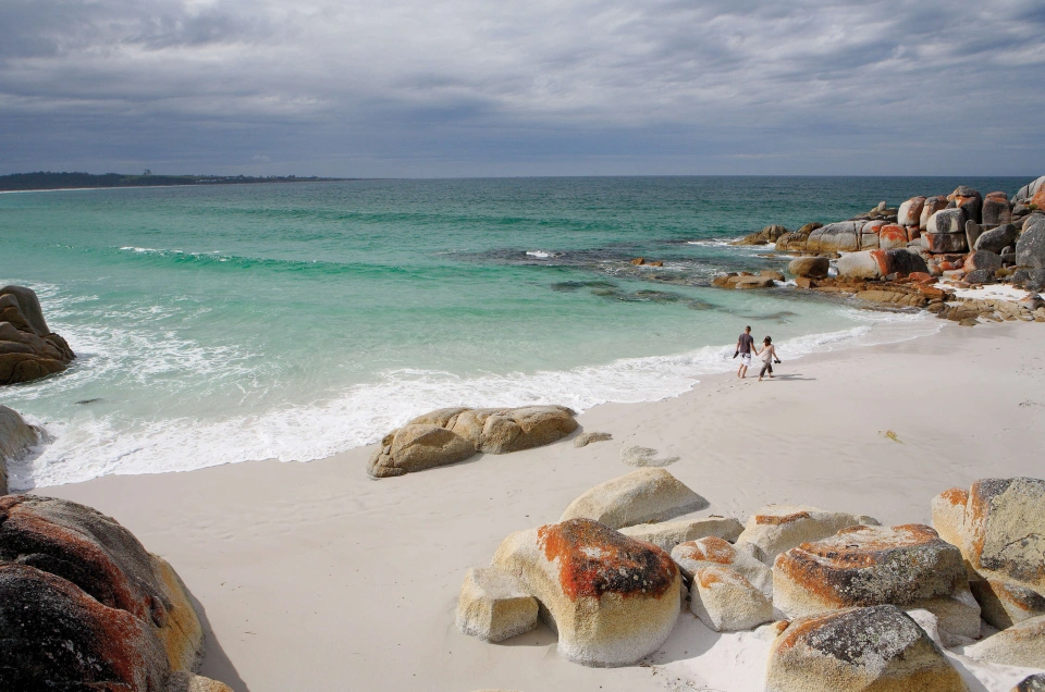 Beach couple walking warm mixed pair